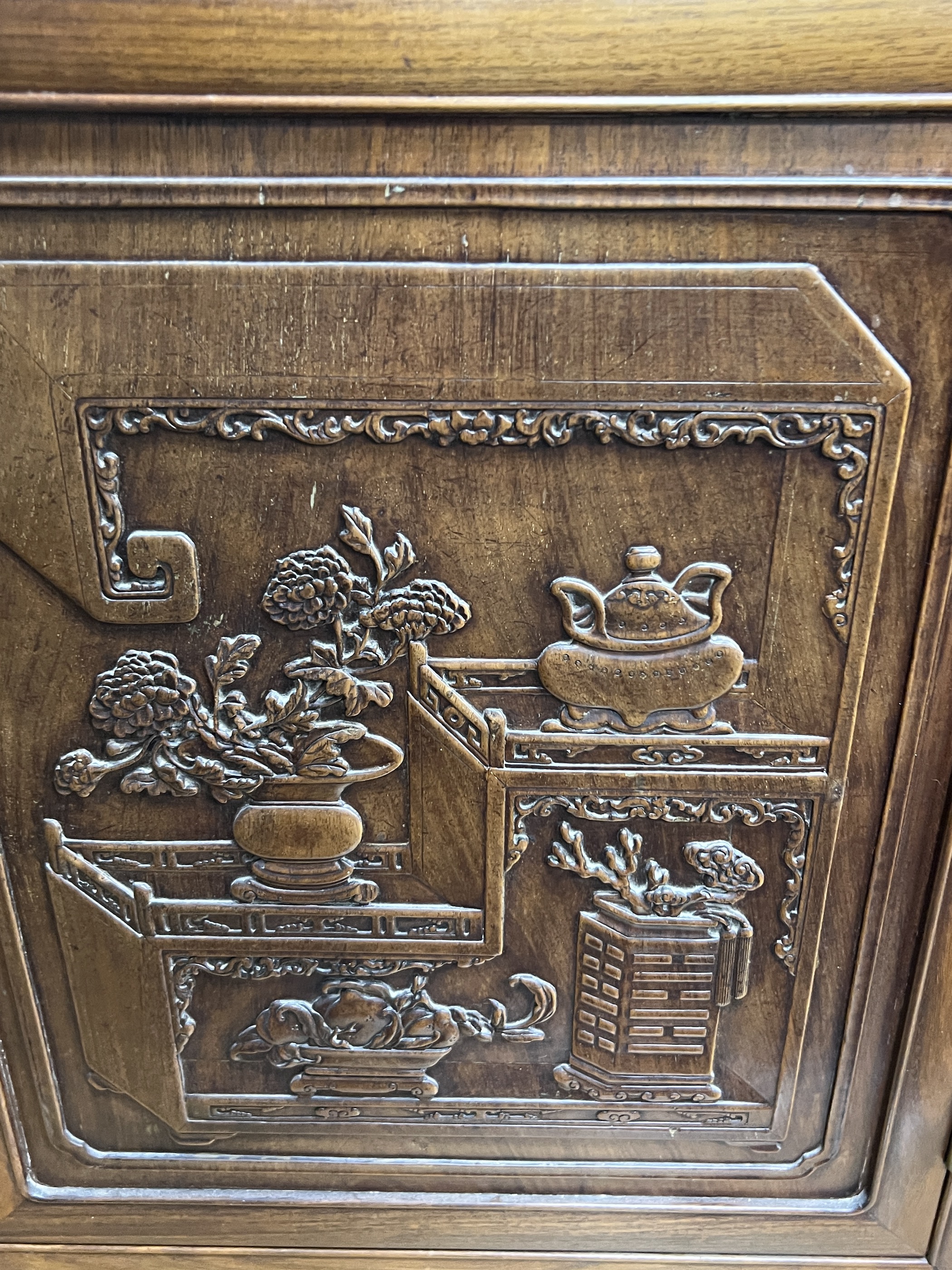 An Asian hardwood side cabinet, width 134cm, depth 44cm, height 84cm